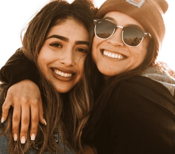 A group of people practicing meditation outdoors in a serene park, surrounded by green trees and soft sunlight